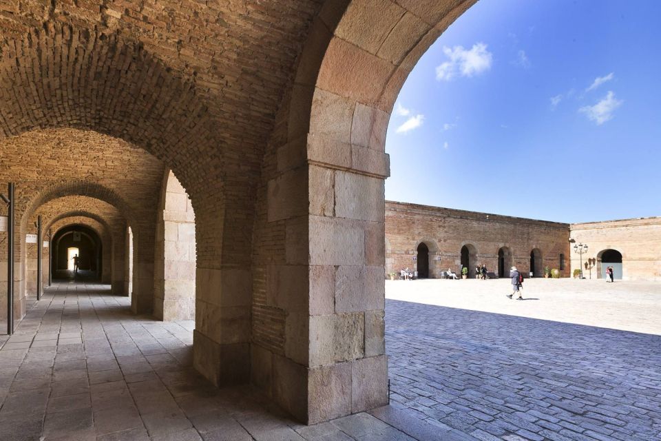 Barcelona Cable Car Sky Views, Magic Fountain & Castle Visit - Inside Montjuïc Castle: Dungeons, Tower Views, and Sunset Light
