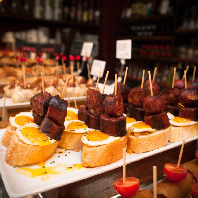 Barcelona: Food & Drink Tasting Tour in Traditional Taverns - Raval walking energy and classic tapas plates