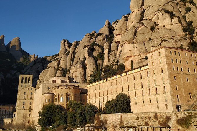 Montserrat Hiking Experience & Monastery Premium Small Group Tour - The Abadia de Montserrat stop: cloister, basilica, and Catalan meaning